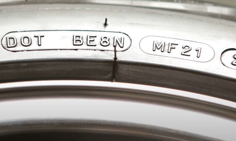 A segment of a vehicle tire displaying important service information