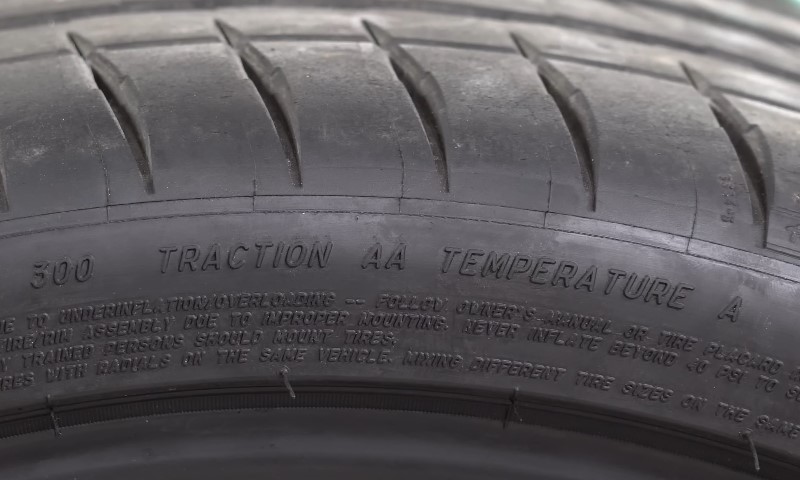 Inspection of the tire's technical data, including "TRACTION" and "TEMPERATURE" markings