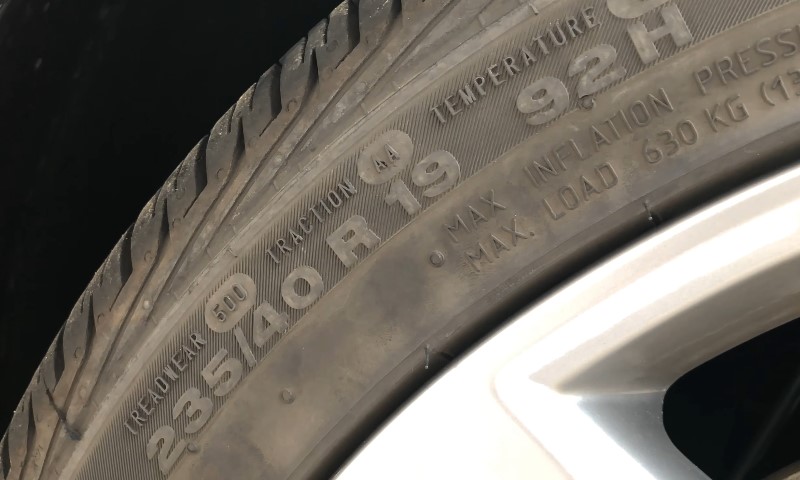 Close-up view of tire sidewall markings, showing size specifications: 235/40R19